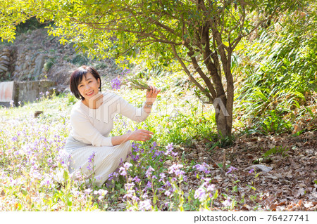 享受春天花朵的中高級婦女 76427741