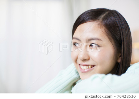 A woman relaxing at home A woman relaxing at home 76428530