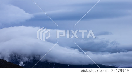 View of Puffy Clouds over the Canadian Mountain Landscape. View of Puffy Clouds over the Canadian Mountain Landscape. 76429949