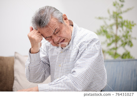 Senior men holding over the eyes 76431027