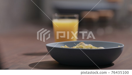 blue bowl with pesto fettuccine on walnut table with orange juice blue bowl with pesto fettuccine on walnut table with orange juice 76435100