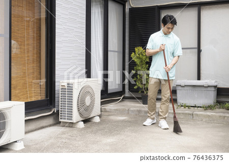 House cleaning man sweeping House cleaning man sweeping 76436375