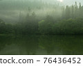 The surface of the water where the morning mist flows 76436452