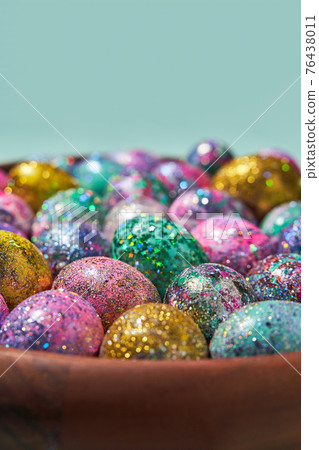 Many colorful shiny eggs. Concept of Happy Easter. 76438011