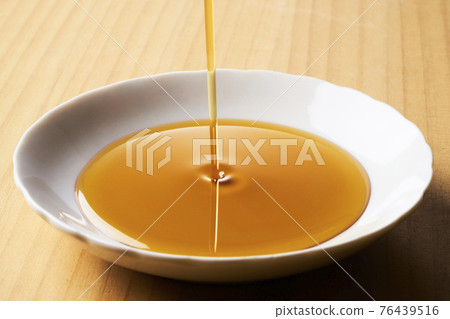 Sesame oil on the plate 76439516