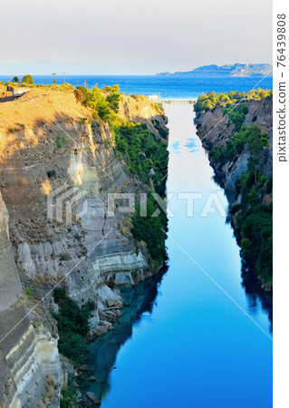 The narrow Corinth Canal in Greece, connecting the Aegean and Ionian Seas. Landscape on a sunny day. 76439808