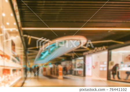 Escalator people blurred background. Interior of retail centre store in soft focus. People shopping in modern commercial mall center. Sale, consumerism and people concept. 76441102