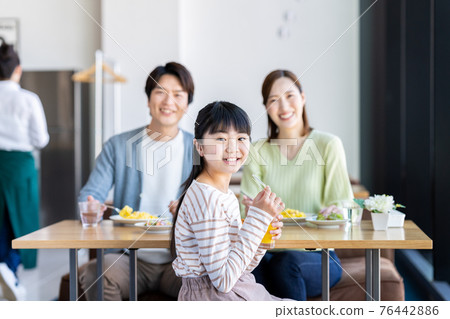Young family eating at a family restaurant 76442886