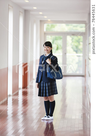 High school student walking in the school corridor High school student walking in the school corridor 76445631