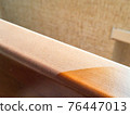 Close up of dust on wooden furniture at home. dirty and clear parts of desk. Domestic hygiene and allergy concept. Dusty texture 76447013