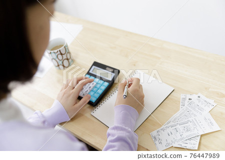 拿著家庭帳簿的婦女 76447989