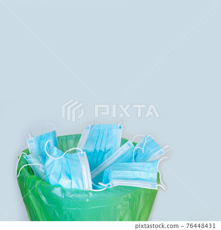 Used mask thrown in trash bin, discarded disposable surgical masks 76448431