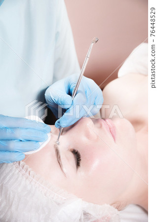 Close-up Professional face cleaning. Mechanical facial cleansing procedure. Peeling of the skin of the face. Close-up Professional face cleaning. Mechanical facial cleansing procedure. Peeling of the skin of the face. 76448529