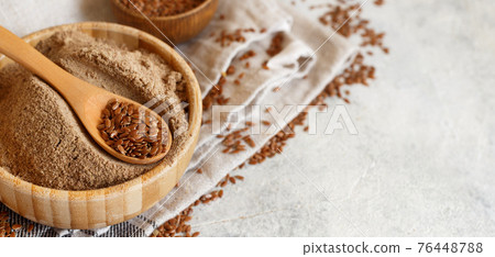 Raw Flax seeds flour in a bowl with a spoon Raw Flax seeds flour in a bowl with a spoon 76448788