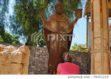 Prayer stands in front of statue of St. Nicolas at the ancient East Roman basilica church. Myra Demre Antalya Turkey Prayer stands in front of statue of St. Nicolas at the ancient East Roman basilica church. Myra Demre Antalya Turkey 76451228