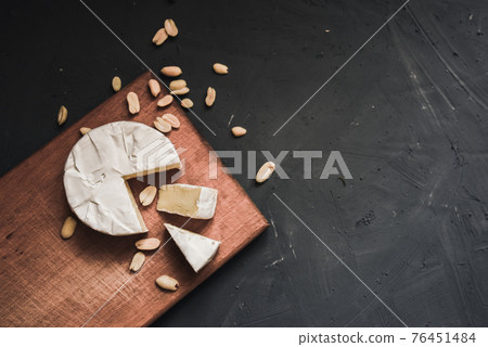 cheese camembert with mold and nuts on wooden board cheese camembert with mold and nuts on wooden board 76451484