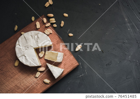 cheese camembert with mold and nuts on wooden board cheese camembert with mold and nuts on wooden board 76451485