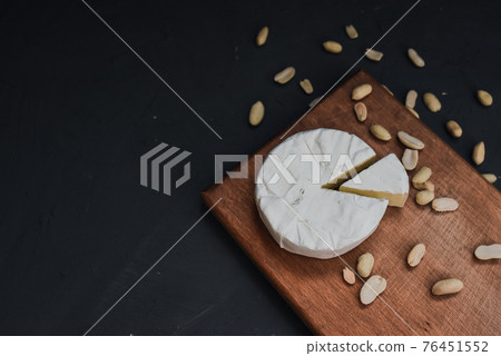 cheese camembert with mold and nuts on wooden board cheese camembert with mold and nuts on wooden board 76451552