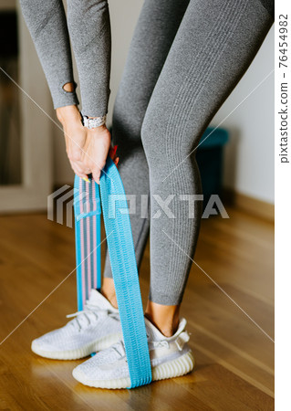 Fit woman fitness butt workout at home. elastic band workout Fit woman fitness butt workout at home. elastic band workout 76454982