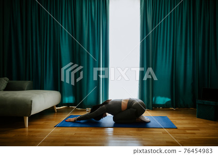 Young woman practicing yoga at home. Posture practicing 76454983