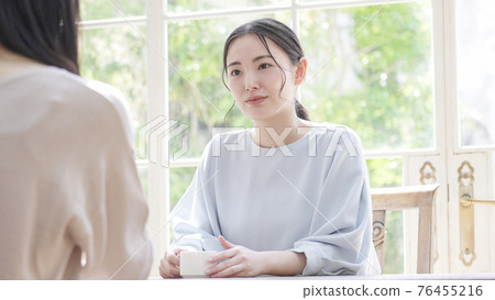 Mother and daughter talking with a smile Mother and daughter talking with a smile 76455216