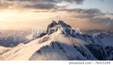 Aerial View from Airplane of Blue Snow Covered Canadian Mountain Landscape 76455299