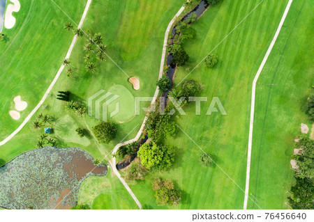 Aerial view drone shot of beautiful green golf field fairway and putting green Top down image for sport background and travel nature background Amazing view 76456640
