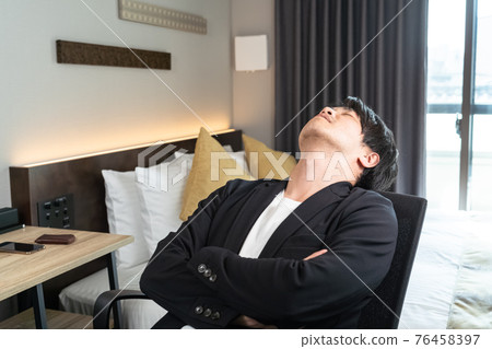 A man taking a break at a business hotel A man taking a break at a business hotel 76458397