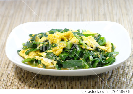 Garlic chives handmade on a white plate Garlic chives handmade on a white plate 76458626