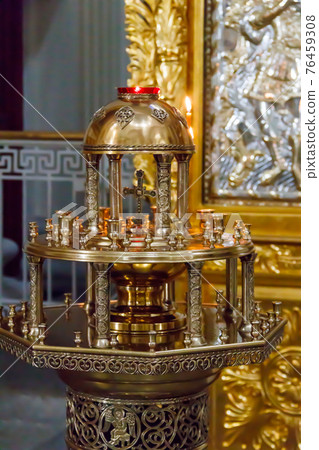 Large church candlestick with burning candles in orthodox church 76459308