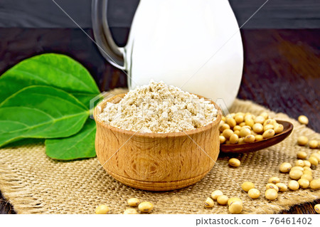 Flour soy in bowl with milk and soybeans on dark board Flour soy in bowl with milk and soybeans on dark board 76461402