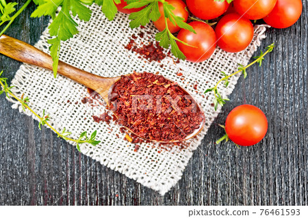 Tomatoes dried in spoon on board top Tomatoes dried in spoon on board top 76461593