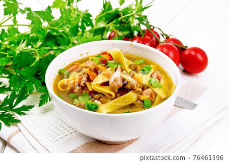 Soup with mung and noodles in bowl on wooden board Soup with mung and noodles in bowl on wooden board 76461596