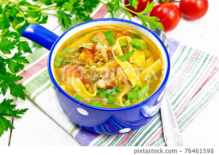 Soup with mung and noodles in blue bowl on white board Soup with mung and noodles in blue bowl on white board 76461598