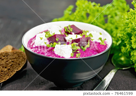 Soup puree of beetroot with salted cheese in bowl on wooden board Soup puree of beetroot with salted cheese in bowl on wooden board 76461599