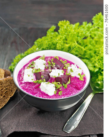 Soup puree of beetroot with salted cheese in bowl on napkin Soup puree of beetroot with salted cheese in bowl on napkin 76461600