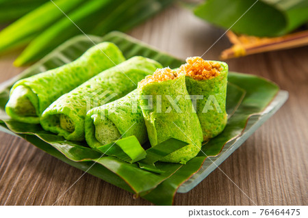 Malaysia popular sweet dessert with coconut known as kuih ketayap Malaysia popular sweet dessert with coconut known as kuih ketayap 76464475
