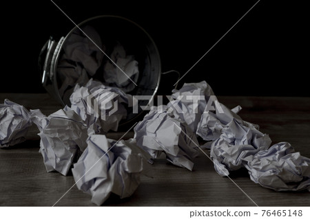 Fallen trash can and scattered documents 76465148