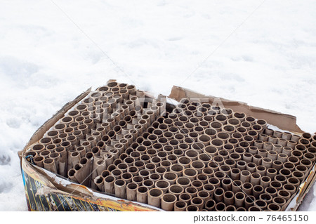 Used fireworks firecrackers on winter snow. Human impact on the environment 76465150