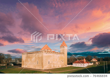 Kuressaare, Saaremaa Island, Estonia. Episcopal Castle In Sunset. Traditional Medieval Architecture, Famous Attraction Landmark. Altered Sky. Traditional Architecture And Famous Place 76466694