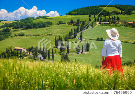 Attractive woman enjoying the view from the hill, Tuscany, Italy Attractive woman enjoying the view from the hill, Tuscany, Italy 76466990