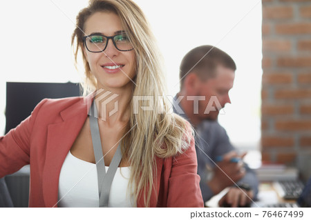 Portrait of smiling businesswoman at workplace in office Portrait of smiling businesswoman at workplace in office 76467499