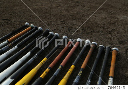 Metal bats lined up on the soil ground Metal bats lined up on the soil ground 76469145