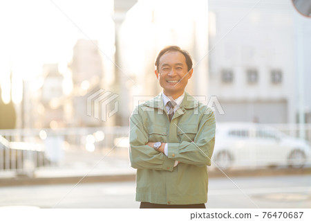 Middle man in work clothes 76470687