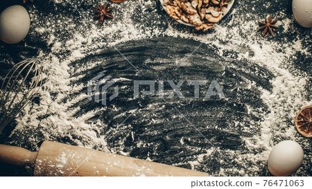 Bakery food. Fresh food ingredients: flour, eggs, nut and star anise, orange on black chalkboard background for bread. Cooking flat lay with copy space. Top view. Baking concept. Bakery food. Fresh food ingredients: flour, eggs, nut and star anise, orange on black chalkboard background for bread. Cooking flat lay with copy space. Top view. Baking concept. 76471063