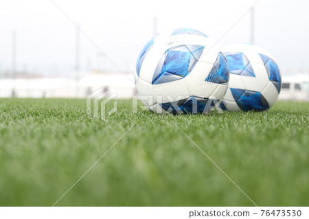 Clean grass soccer pitch and soccer ball 76473530