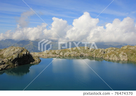 Shore of lake Schottensee. Summer clouds. Shore of lake Schottensee. Summer clouds. 76474370