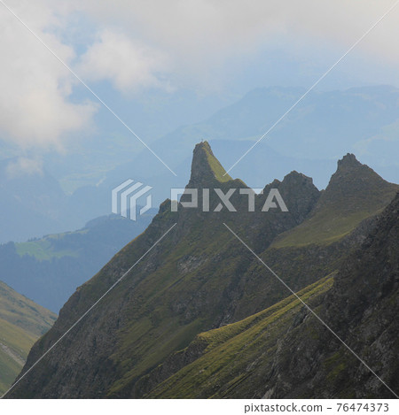 Hazy summer morning in the Swiss Alps. Hazy summer morning in the Swiss Alps. 76474373