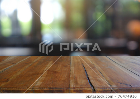 Empty wooden table in front of abstract blurred Cafe, restaurant at night. For montage product display or design key visual layout - Image Empty wooden table in front of abstract blurred Cafe, restaurant at night. For montage product display or design key visual layout - Image 76474916