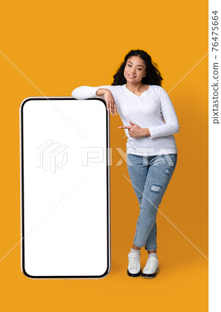 Smiling African American Lady Leaning At Big Smartphone With White Screen, Mockup 76475664